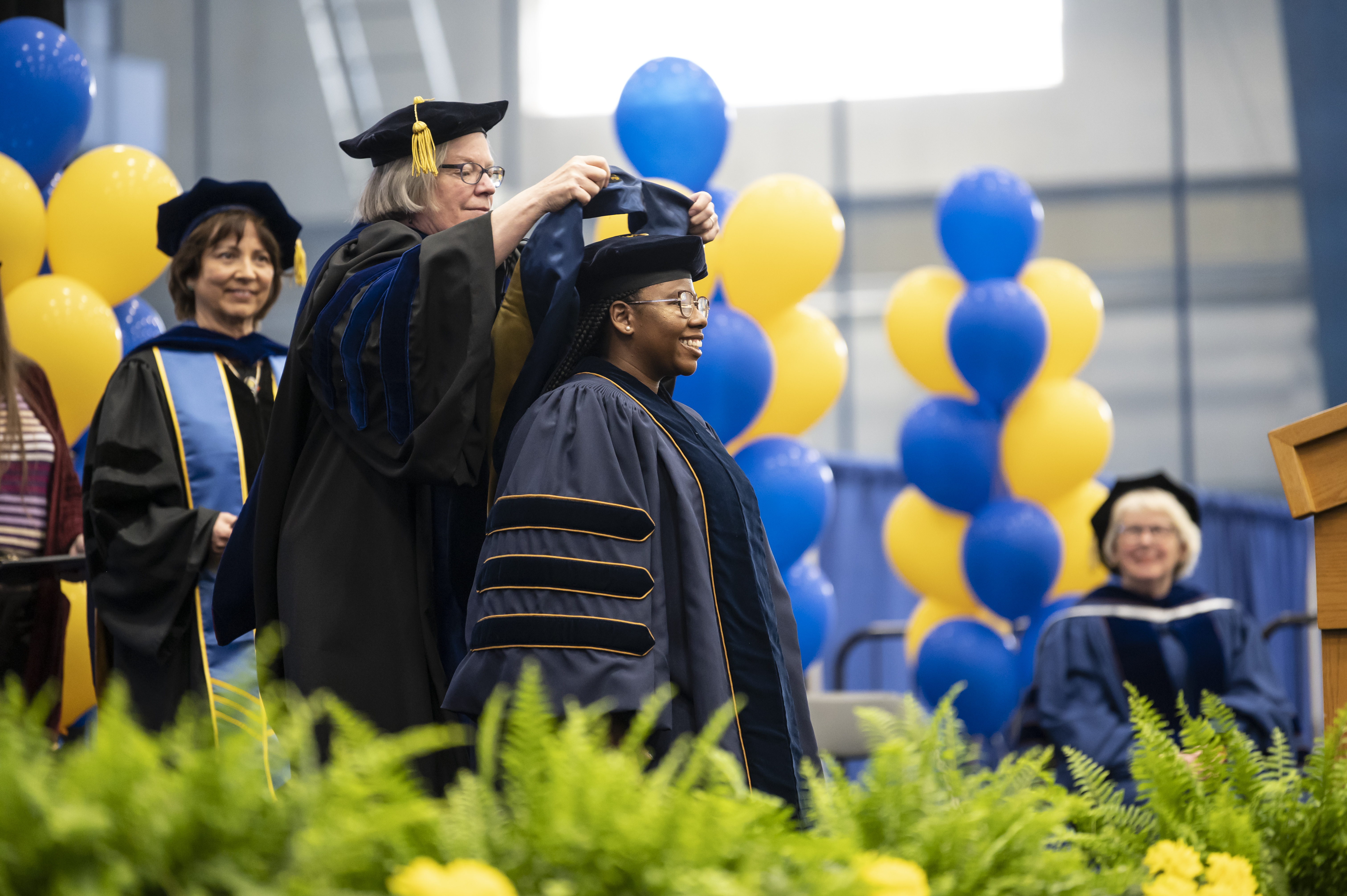 Student receives doctoral hood from Dean Blee