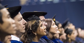 Graduating students listening to speach during graduation ceremony